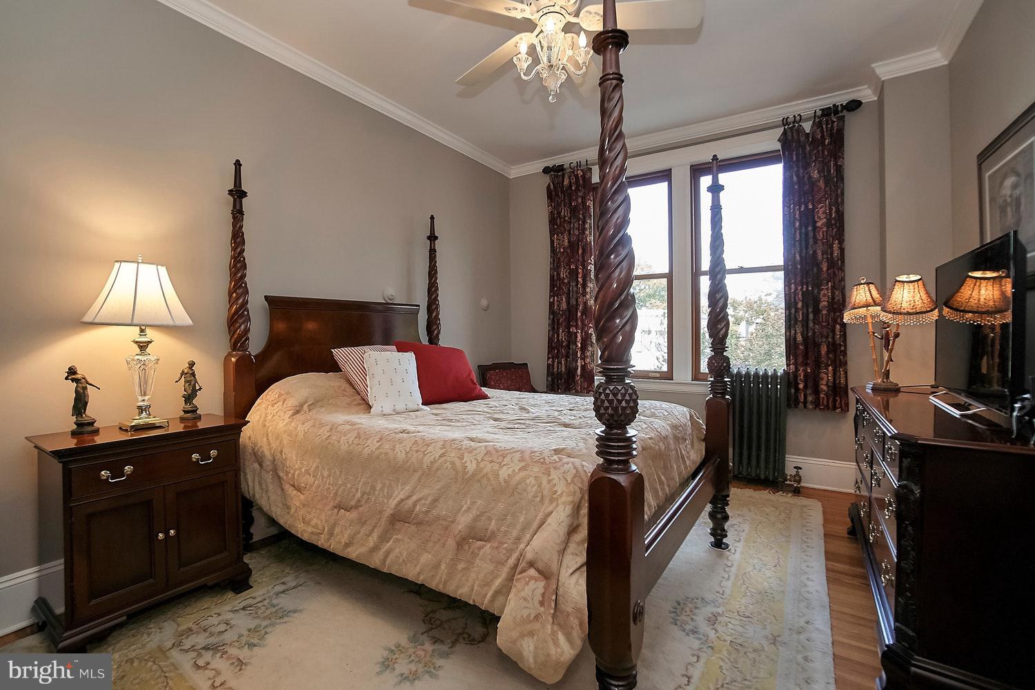2220 20th Street Northwest, Unit 32 Washington, DC 20009 - Photo 12 of 20 a bedroom with a bed and a flat tv screen on a dresser