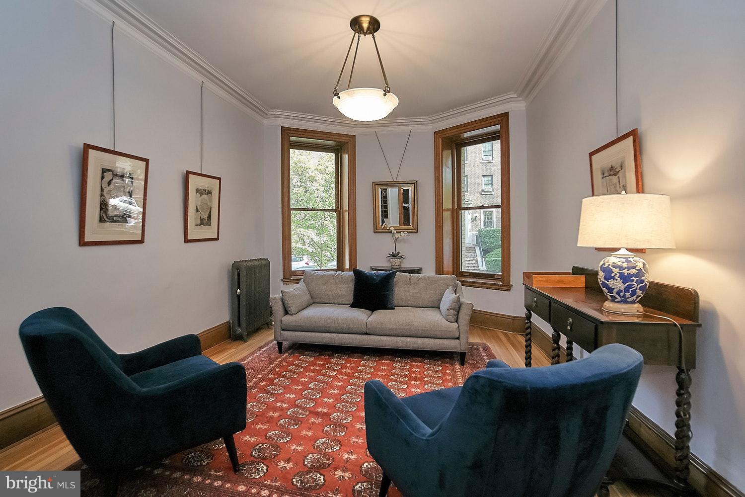 2220 20th Street Northwest, Unit 32 Washington, DC 20009 - Photo 17 of 20 a living room with furniture a lamp and a chandelier