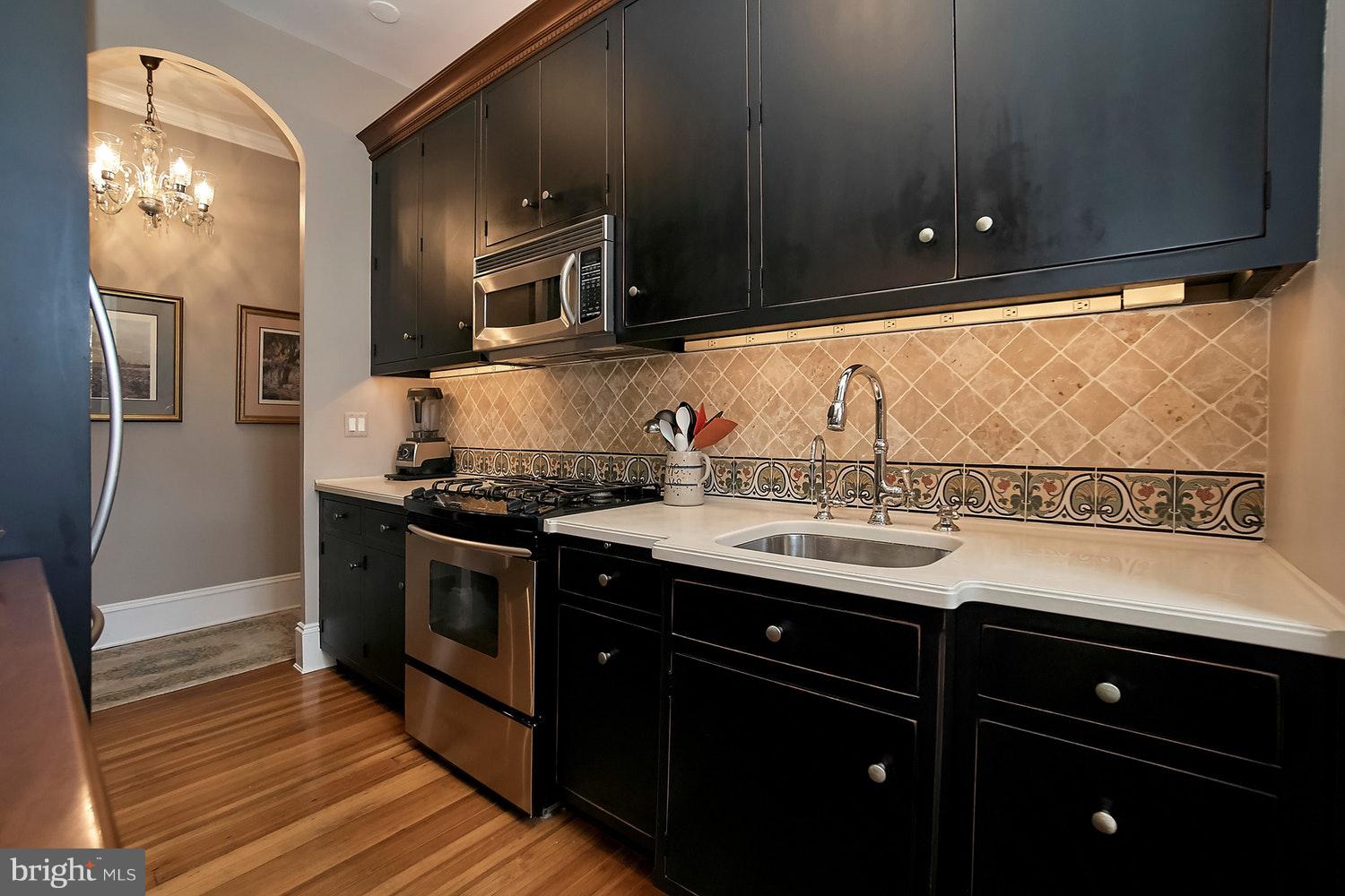 2220 20th Street Northwest, Unit 32 Washington, DC 20009 - Photo 3 of 20 a kitchen with a sink and stainless steel appliances