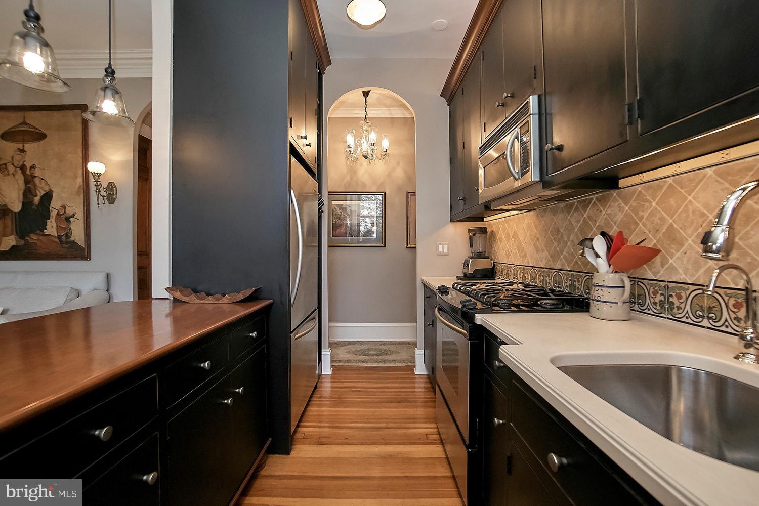 2220 20th Street Northwest, Unit 32 Washington, DC 20009 - Photo 20 of 20 a kitchen with a sink stove and cabinets