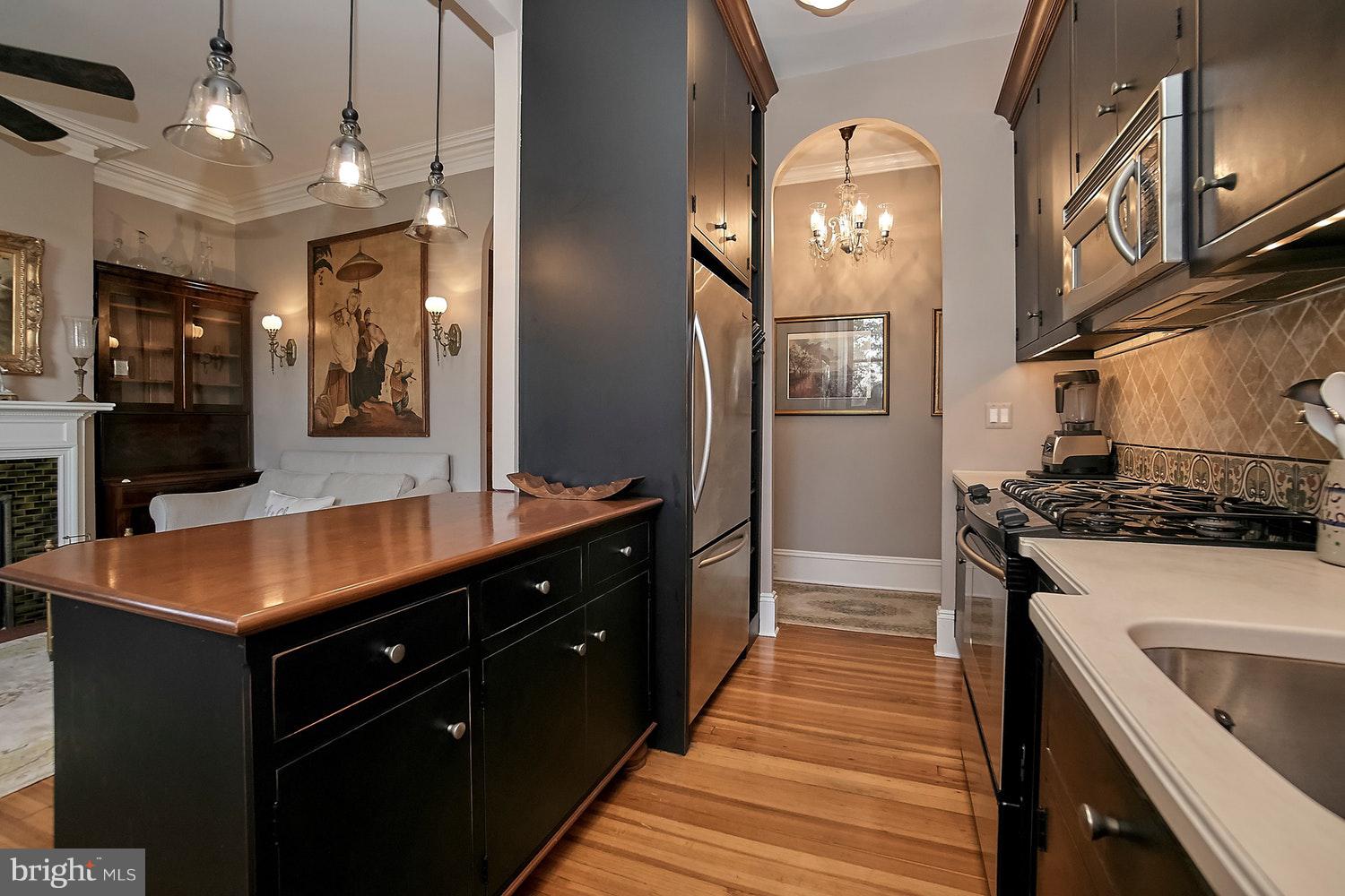 2220 20th Street Northwest, Unit 32 Washington, DC 20009 - Photo 4 of 20 a kitchen with stainless steel appliances granite countertop a stove a sink and a refrigerator