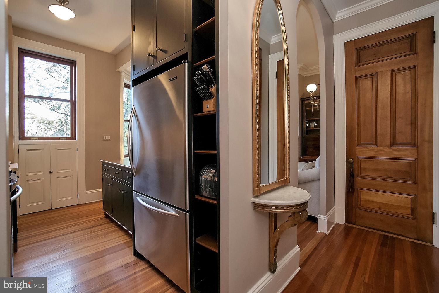 2220 20th Street Northwest, Unit 32 Washington, DC 20009 - Photo 6 of 20 a view of a refrigerator in kitchen and an empty room