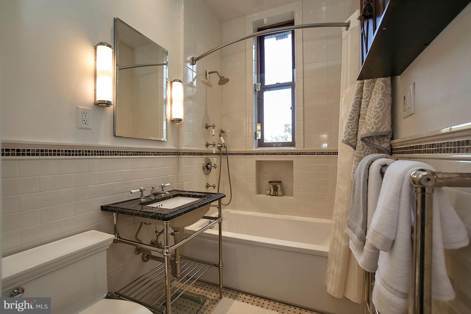 2220 20th Street Northwest, Unit 32 Washington, DC 20009 - Photo 9 of 20 a bathroom with a sink a toilet a mirror and bathtub