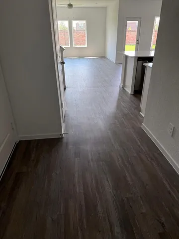 wooden floor in an empty room with a window