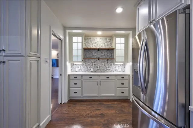 a bathroom with a granite countertop sink mirror and shower