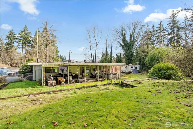 a view of a house with yard and sitting area