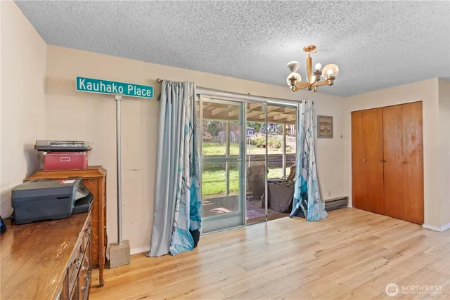 a view of a livingroom with wooden floor and a window