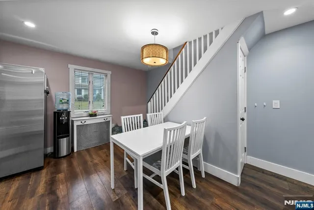 a view of a room with furniture and wooden floor