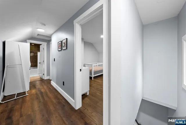 a view of hallway with walk in closet and bathroom