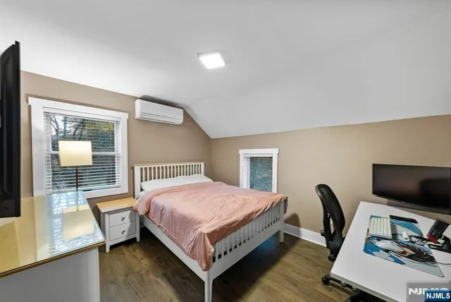 a bedroom with a bed a desk and chair