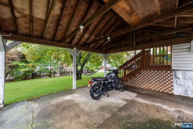 a car parked in front of a house with a big yard
