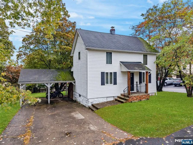 a view of a house with a yard and sitting area