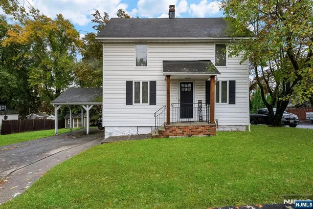 a front view of a house with a garden and yard