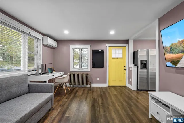 a room with wooden floor and furniture