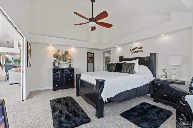 a bedroom with a bed and ceiling fan