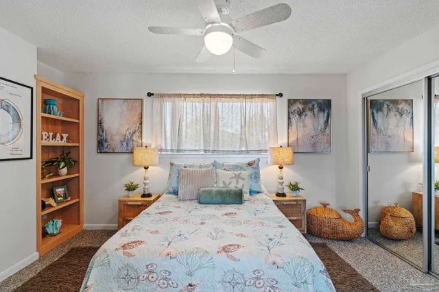 a bedroom with a large bed and a bookshelf