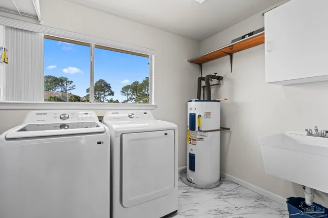 a view of washer and dryer with kitchen in the background