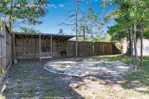 23596 Goode Road Cleveland, TX 77328 - Photo 5 of 14 a view of a backyard with large trees and wooden fence