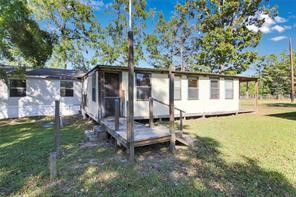 23596 Goode Road Cleveland, TX 77328 - Photo 7 of 14 a house with trees in the background