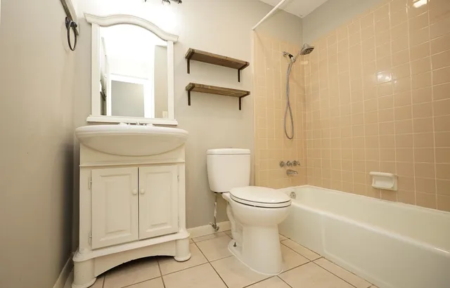 a bathroom with a toilet a sink and bathtub