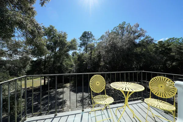 a view of balcony with wooden floor and outdoor seating