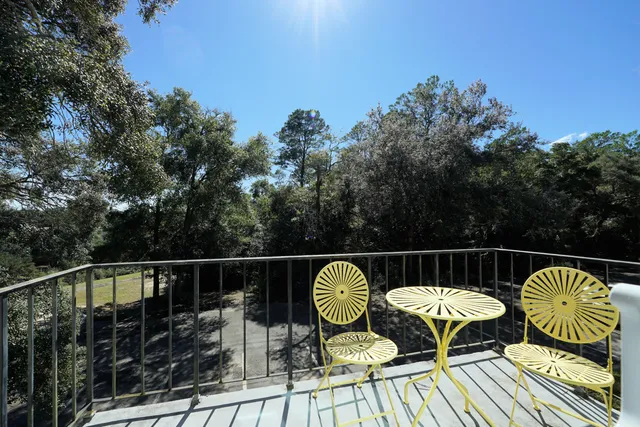 a view of balcony with wooden floor and outdoor seating