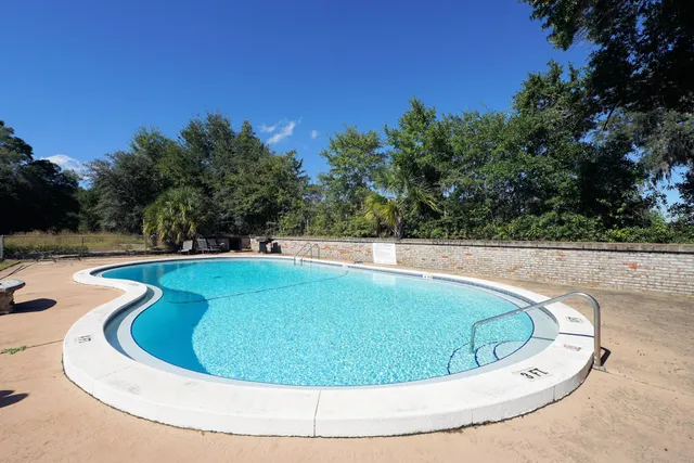 a view of a swimming pool with a yard