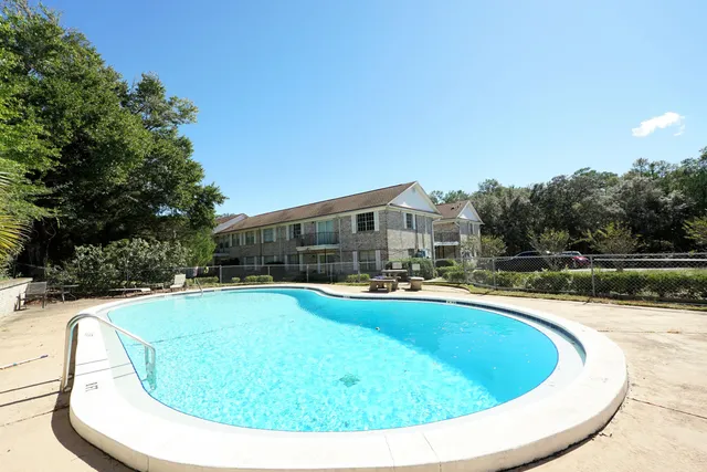 a view of swimming pool with outdoor seating and yard in back