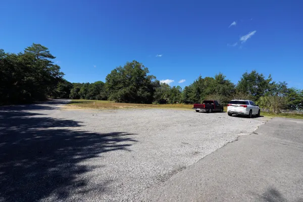 a view of a lake with a car parked on the road