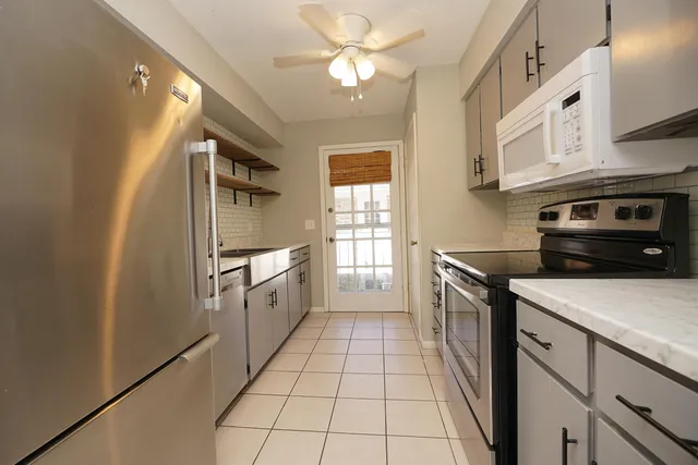 a kitchen with a stove a sink and a refrigerator