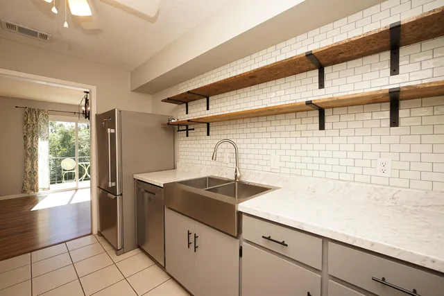 a kitchen with stainless steel appliances granite countertop a sink and cabinets