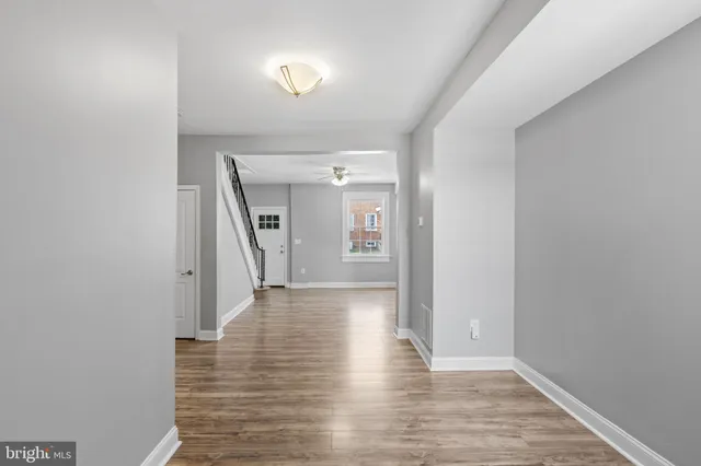 a view of a hallway view with wooden floor and staircase