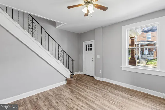 a view of an entryway with wooden floor and stairs