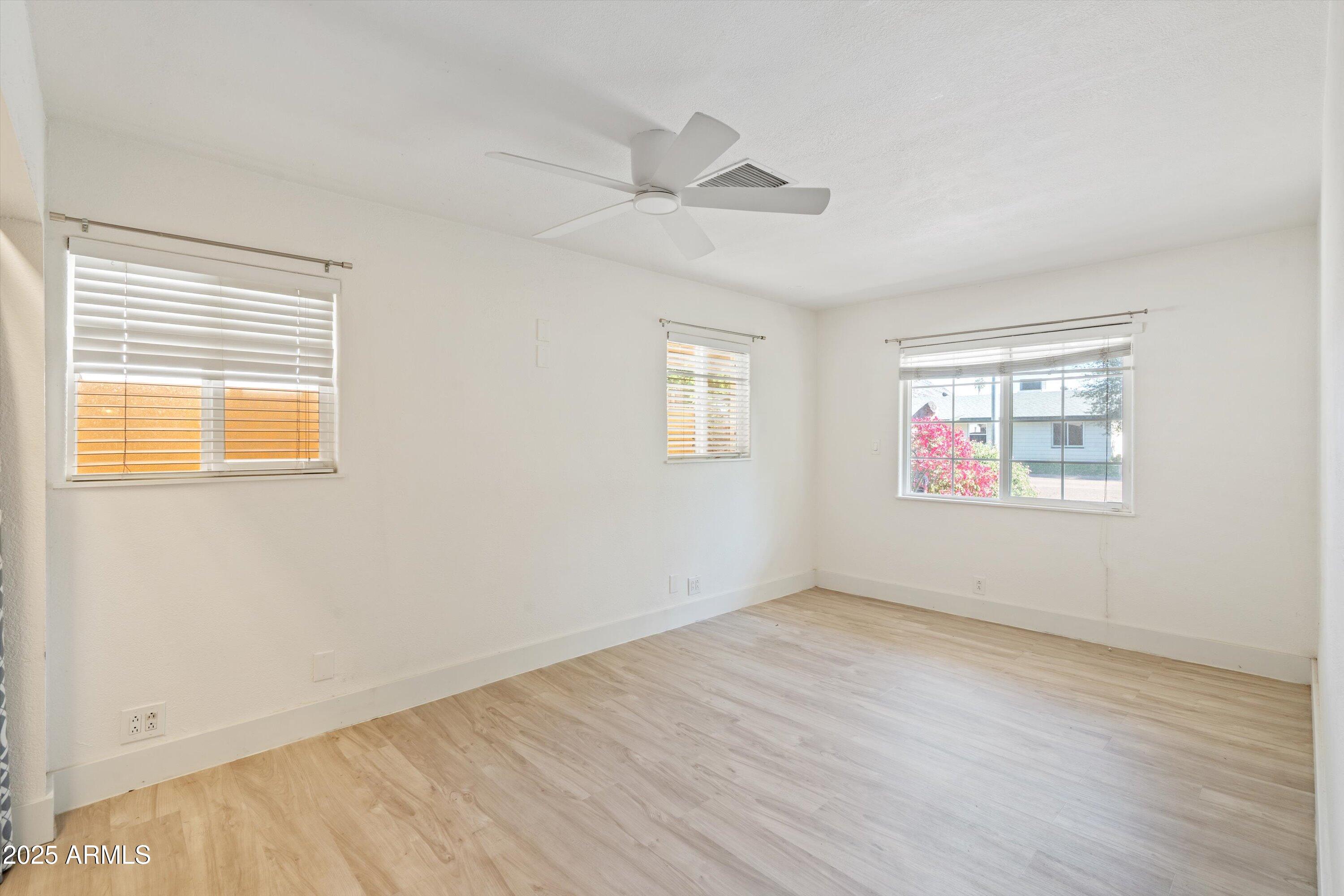 8216 North 9th Street Phoenix, AZ 85020 - Photo 13 of 38 a view of an empty room with wooden floor and a window