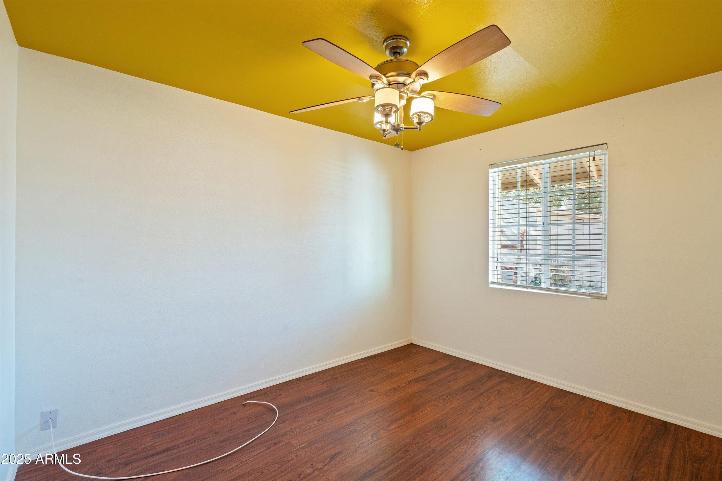 8216 North 9th Street Phoenix, AZ 85020 - Photo 16 of 38 a view of an empty room with wooden floor and a window