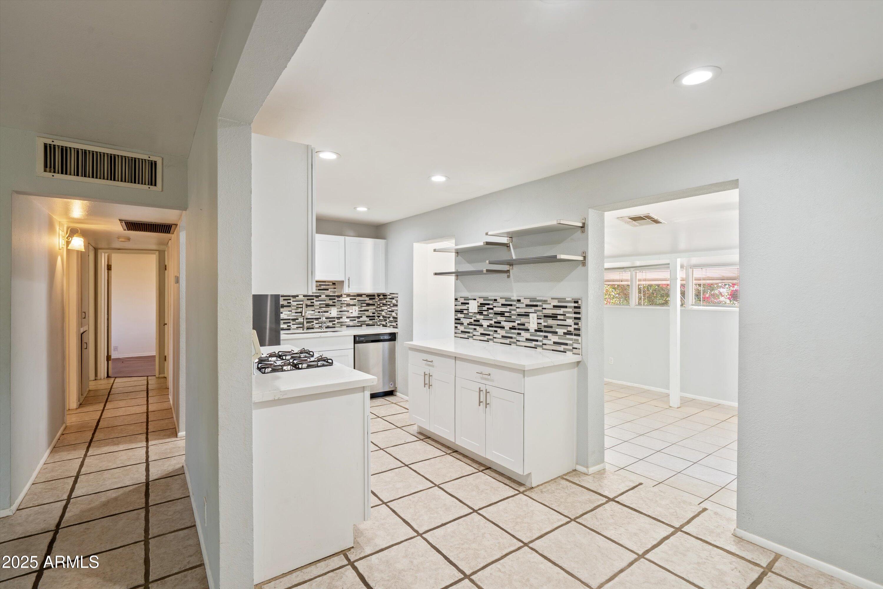8216 North 9th Street Phoenix, AZ 85020 - Photo 6 of 38 a kitchen with white cabinets and appliances