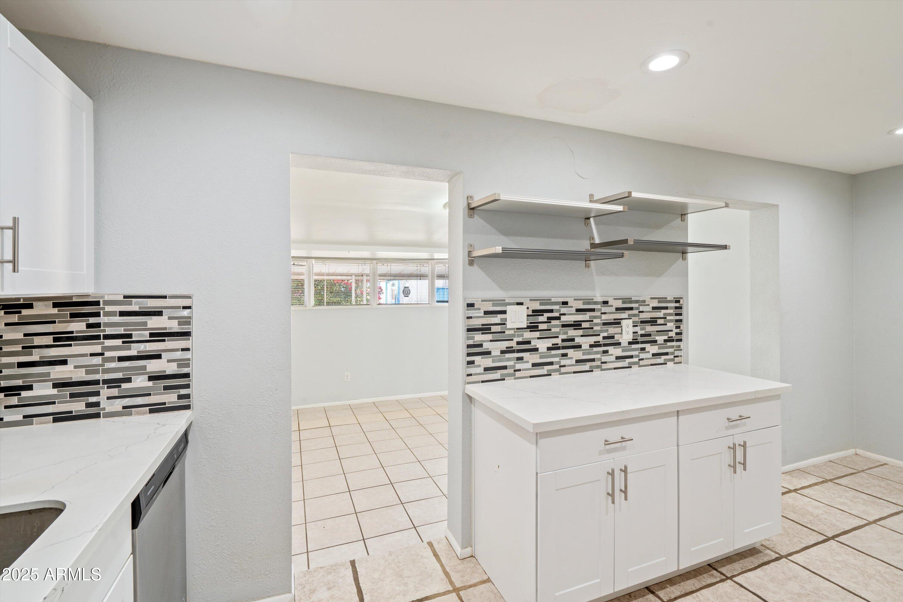 8216 North 9th Street Phoenix, AZ 85020 - Photo 8 of 38 a kitchen with white cabinets and appliances