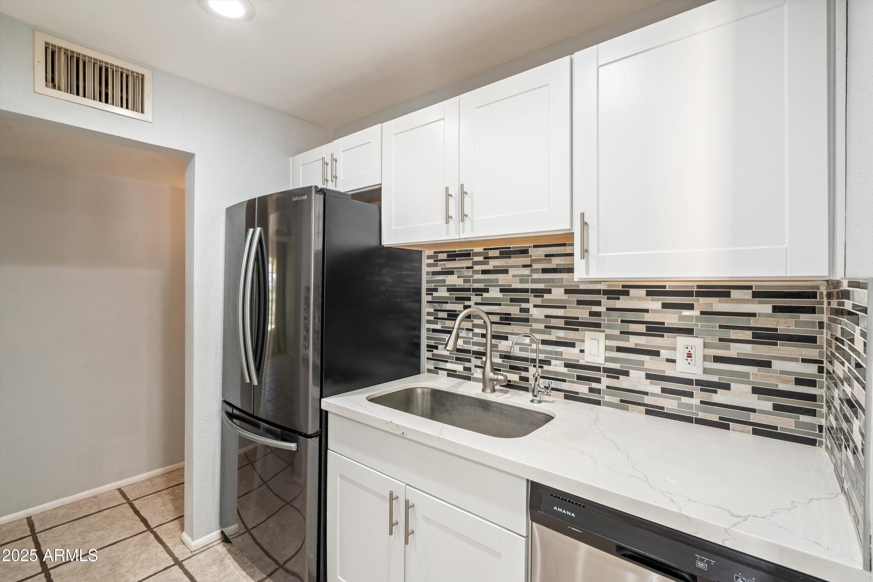 8216 North 9th Street Phoenix, AZ 85020 - Photo 9 of 38 a kitchen with stainless steel appliances a refrigerator sink and microwave
