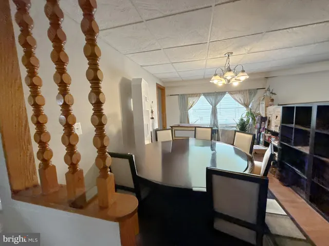 a view of a dining room with furniture and a chandelier