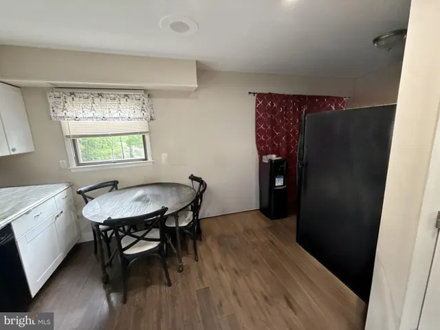 a view of a room that has a table and a chair in it