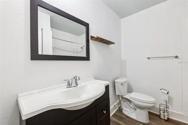 a bathroom with a sink a toilet and mirror