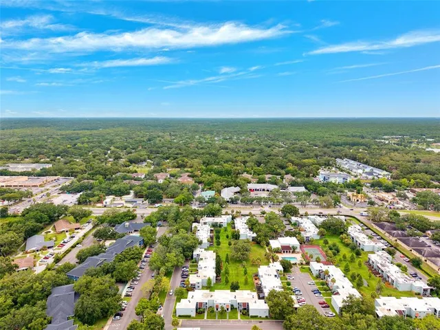 an aerial view of residential houses with outdoor space and street view