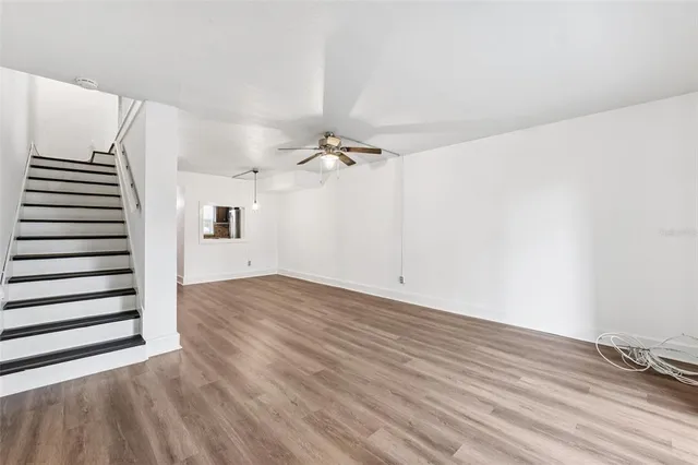 a view of a room with wooden floor and white walls