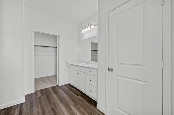 a view of a hallway to closet and mirror