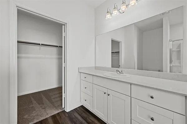 a bathroom with a double vanity sink and mirror