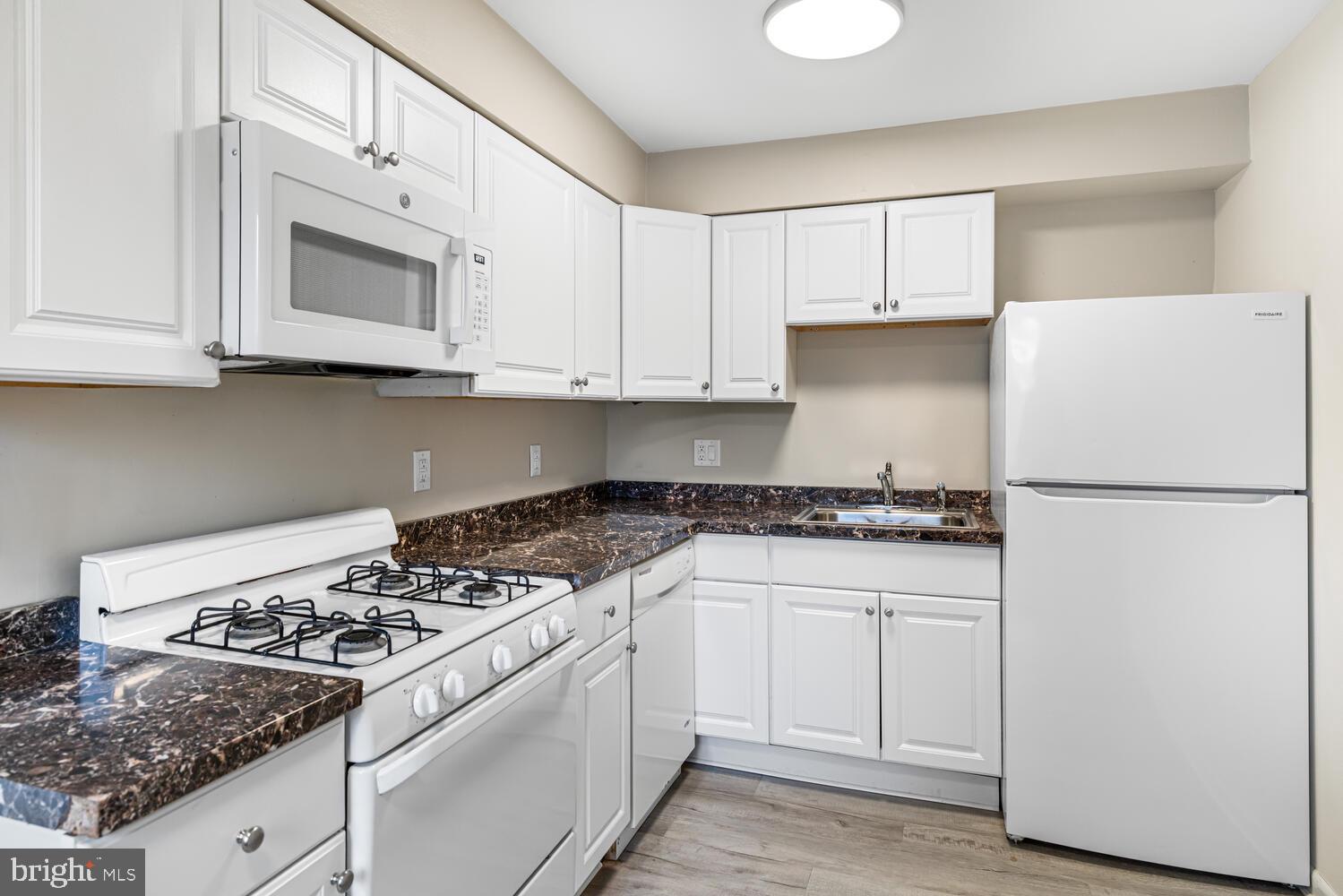 1600 Church Road, Unit D205 Wyncote, PA 19095 - Photo 10 of 21 a kitchen with white cabinets and white appliances