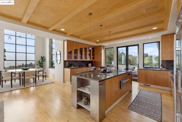 a kitchen with stainless steel appliances granite countertop a stove and cabinets