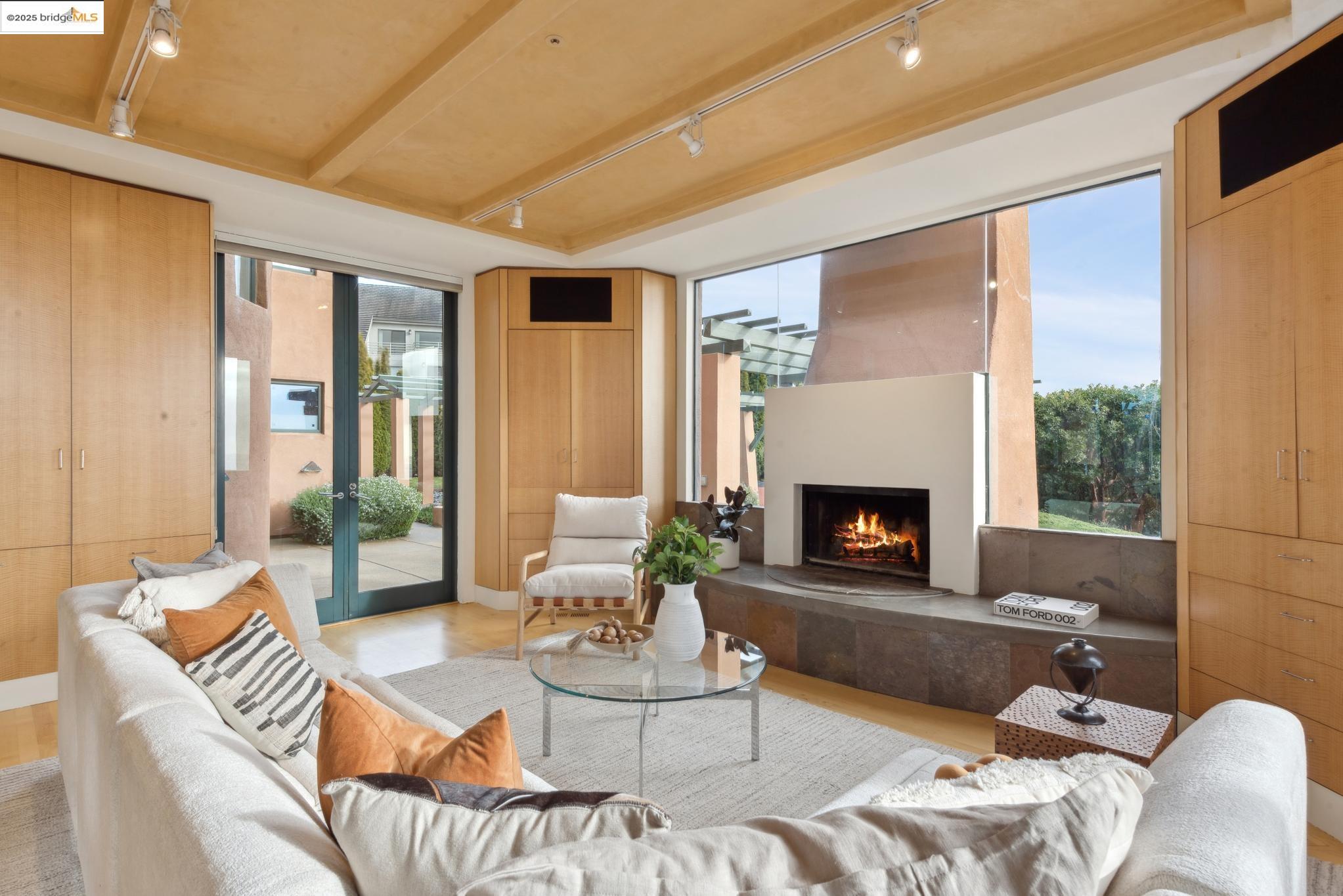 5 Woodside Way Oakland, CA 94611 - Photo 22 of 59 a living room with furniture a fireplace and a large window