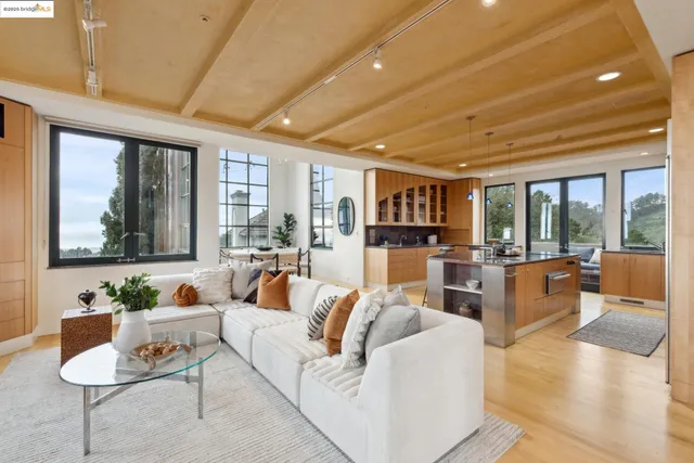 a living room with kitchen island furniture and a potted plant