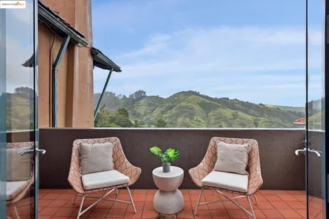 a living room with furniture a dining table and a large window